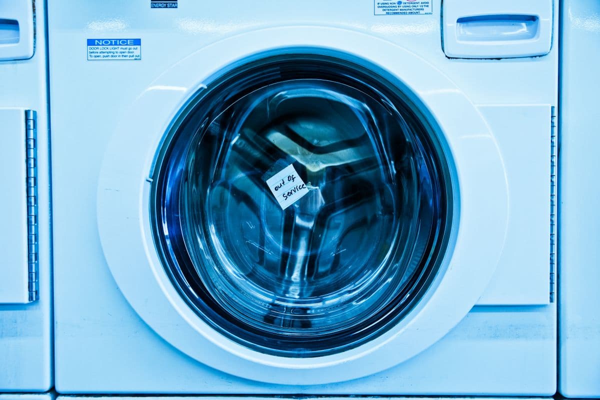 Front-load washing machine being repaired by an RK Aircon technician in Chennai